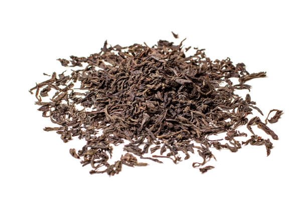 istock dry black tea leaves isolated on white 1332325941