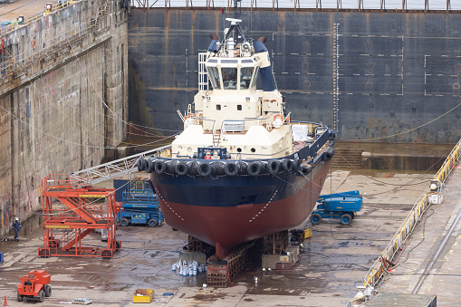 Small boat undergoing repairs in a dry dock in the Cornish town of Falmouth in the south west of England