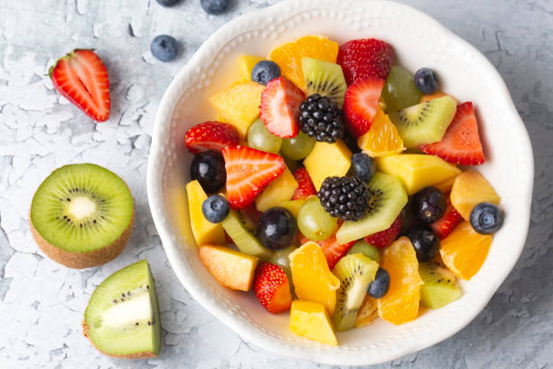 istock Dietary fruit salad with fresh summer fruits 1332333139