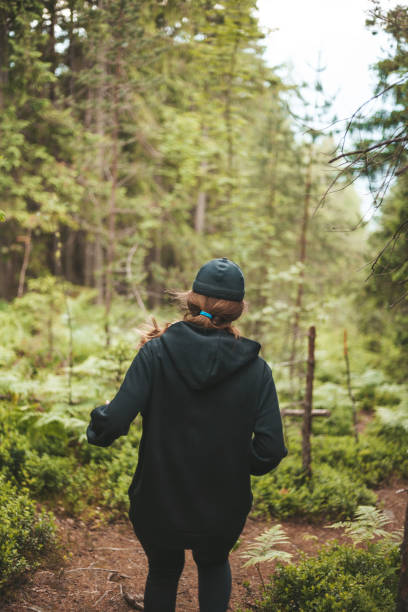 istock Woman runner in the forest. Endurance training with nature 1332335284