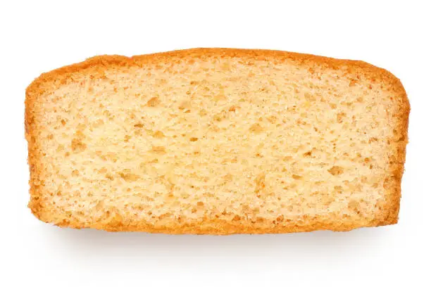 Slice of plain sponge cake isolated on white. Top view.