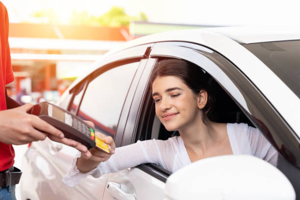 woman customer paying by credit card gas station. refuelling car and service payment with wireless bank payment terminal concept - gas station gasoline refueling fuel pump imagens e fotografias de stock