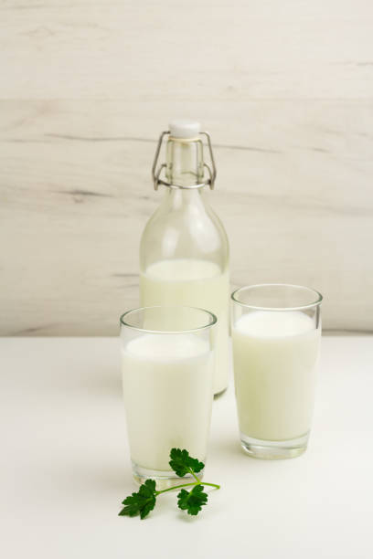 istock Kefir, ayran, yoghurt in glasses with greens 1332336436