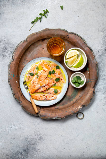 istock Salmon carpaccio. Salmon marinated in lemon. Top view 1332336958