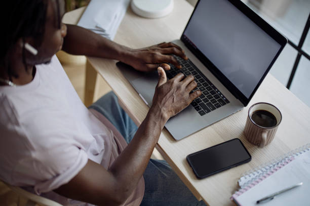 istock Top view of a young man works from home office using laptop 1332337013