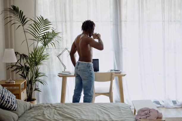 istock Good looking young shirtless man drinking coffee in his apartment 1332337778