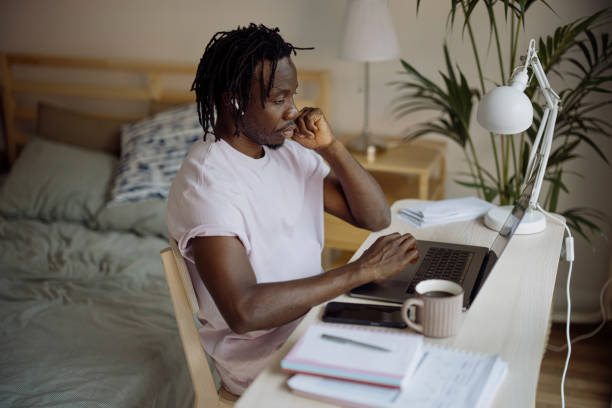 istock A young man works from home office using laptop 1332337901