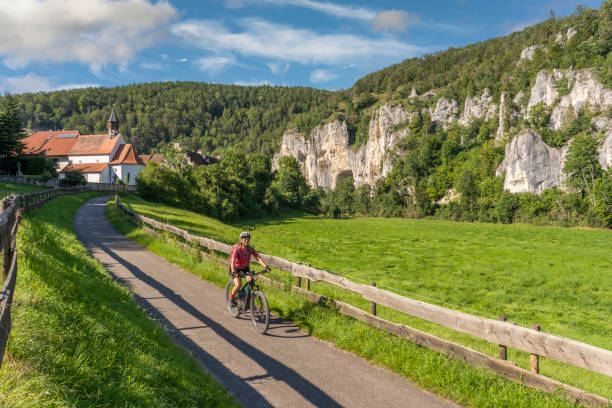 senior woman with electric mountain bike in the danube valley, germany - 2127 imagens e fotografias de stock