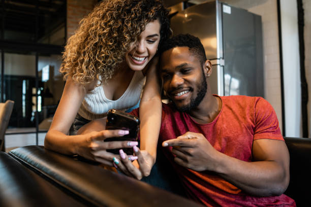 istock Young couple using a mobile phone at home. 1332338394