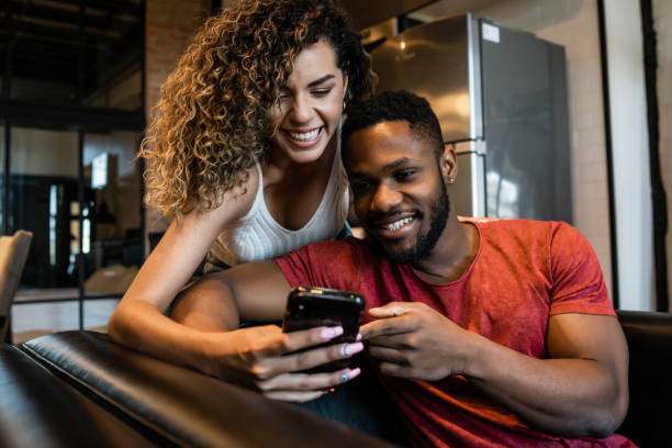 istock Young couple using a mobile phone at home. 1332338396