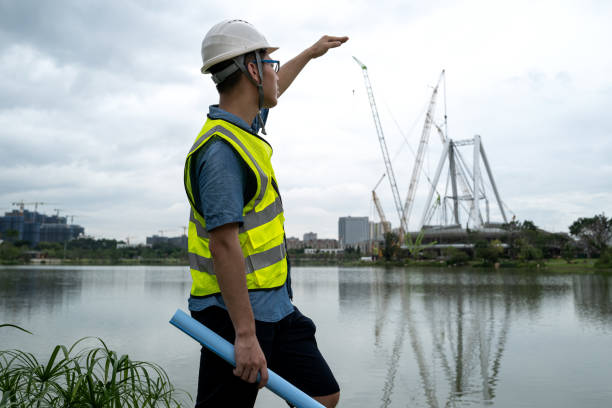 istock Young male engineer by the water at the construction site 1332339428