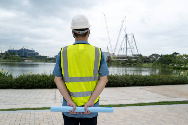istock Back view of young male engineer at construction site 1332339494