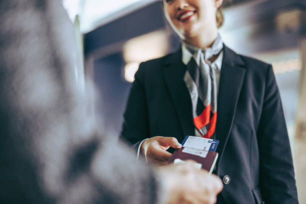 Boarding checking at departure gate Cropped shot of airlines staff checking passenger at check-in counter. Flight attendant checking tourist boarding pass at airport. airline check in attendant stock pictures, royalty-free photos & images