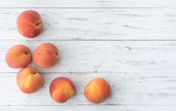 istock A group of peaches over wooden table with copy space 1332343082