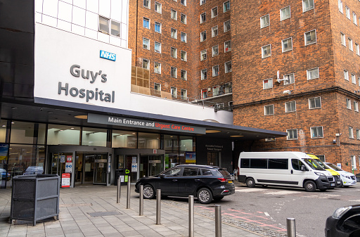 London, UK - A sign over the main entrance to Guy's Hospital, an NHS hospital located in Southwark, London.