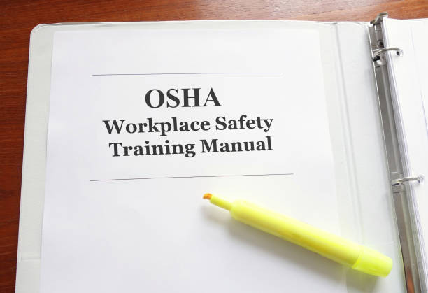 OSHA (Occupational Safety and Health Administration) manual on a desk -- safe workplace concept
