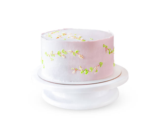 istock Wedding pink cake on a stand isolated on white background 1332344792