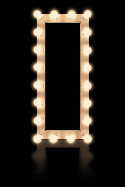 istock Vintage white mirror frame with glowing lamps, isolated on black background. Make-up mirror with built-in lamps. Professional luminous mirror with reflection. 1332346937