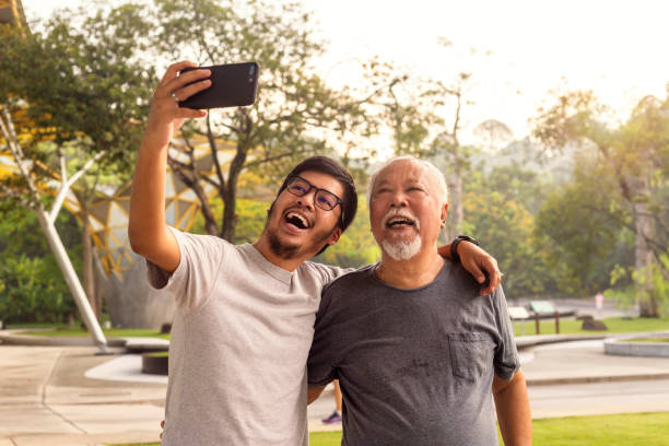 istock Dad and son taking selfie and having fun in the park 1332348757