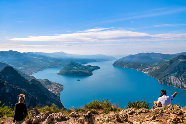 People admiring the outstanding view from the Corna Trentapassi, a mountain on the eastern shore of the Lake Iseo.