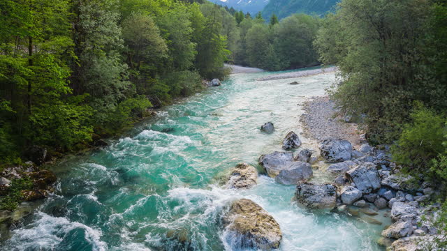 Idyllic emerald river in lush green mountain valley