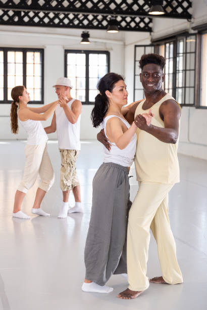 istock Positive people dancing twist together at dance studio 1332358649