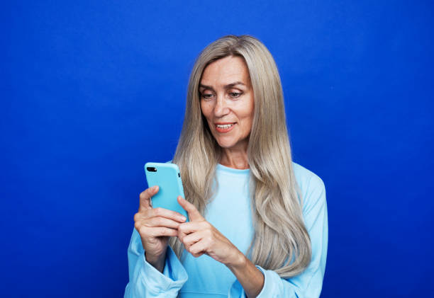 istock elderly woman selfie mobile isolated 1332362107