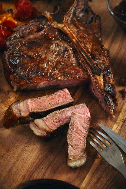 istock BBQ T-Bone Steak with Roasted Asparagus and Tomatoes 1332363361