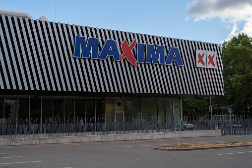 Tallinn, Estonia - July 30 2021: Grocery store Maxima XX in Pelguranna district on a cloudy summer day. Empty parking in the front of the store.