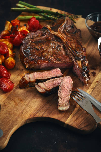 istock BBQ T-Bone Steak with Roasted Asparagus and Tomatoes 1332363446