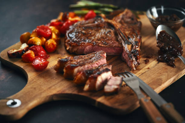 istock BBQ T-Bone Steak with Roasted Asparagus and Tomatoes 1332363512