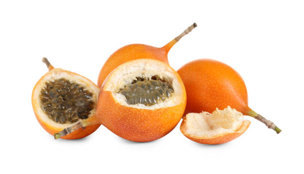istock Whole and cut delicious granadillas on white background 1332364405