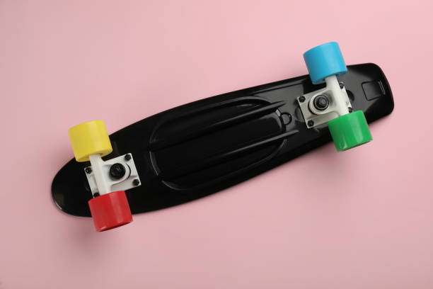 istock Black skateboard on pink background, top view 1332364489