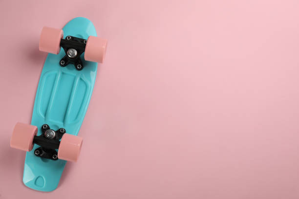 istock Skateboard on pink background, top view. Space for text 1332364490