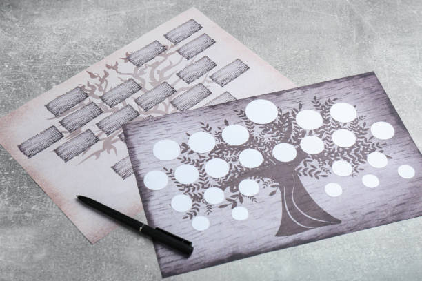 istock Blank family tree charts and pen on grey table 1332364649