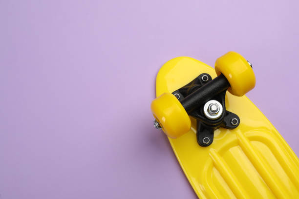 istock Skateboard on lilac background, top view. Space for text 1332364672