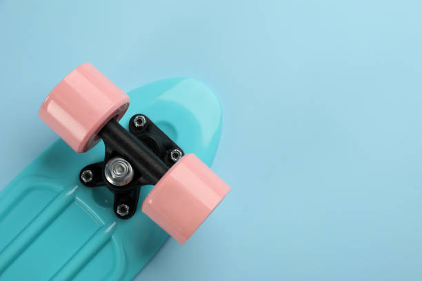 istock Skateboard on turquoise background, top view. Space for text 1332364694