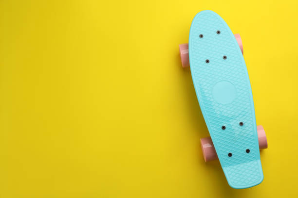 istock Skateboard on yellow background, top view. Space for text 1332364716
