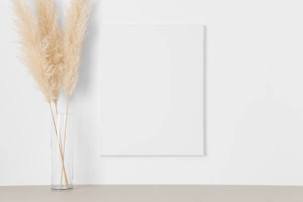 istock White canvas mockup on the wall with  pampas decoration. 1332364746