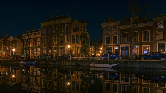 View of the illuminated city at night with reflections in the water, Leiden Netherlands