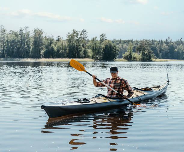 istock Man kayaking on lake in summer. 1332371195