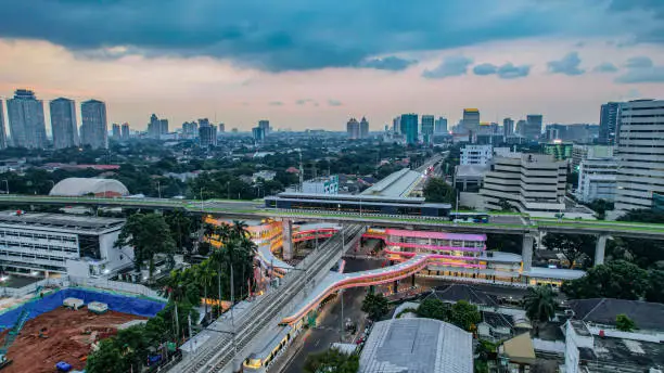 Photo of Aerial view of articulated city buses arriving and leaving at bus station near main railway station MRT line at Kebayoran Baru. Jakarta, Indonesia