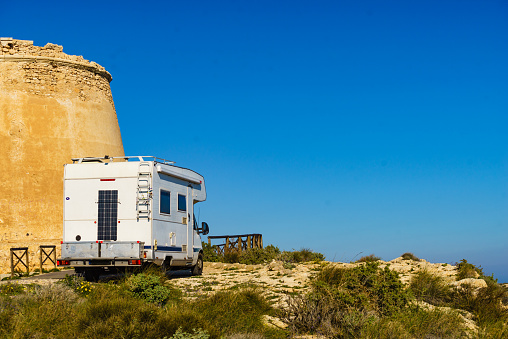 Rv caravan at Mesa Roldan tower. Visiting Cabo de Gata Nijar Natural Park in Almeria province, Andalusia Spain. Tourist attraction, Defense towers.