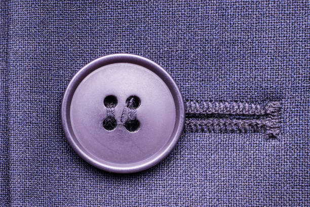 Button on a suit jacket close-up. Rules for wearing business suits, dress code concept