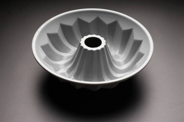 Gray silicone cupcake baking pan on black background, selective focus