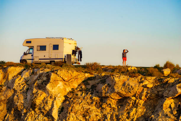 istock Camper camping on cliff rock, Spain 1332374186