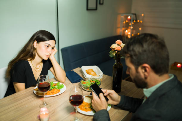 istock Angry wife waiting for her husband to pay attention 1332377351