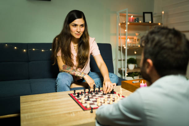 istock Beautiful couple playing a board game at home 1332377383