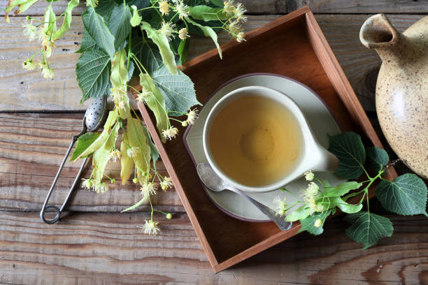 istock Lime leaf tea. Cup of herbal tea with linden flowers 1332377428