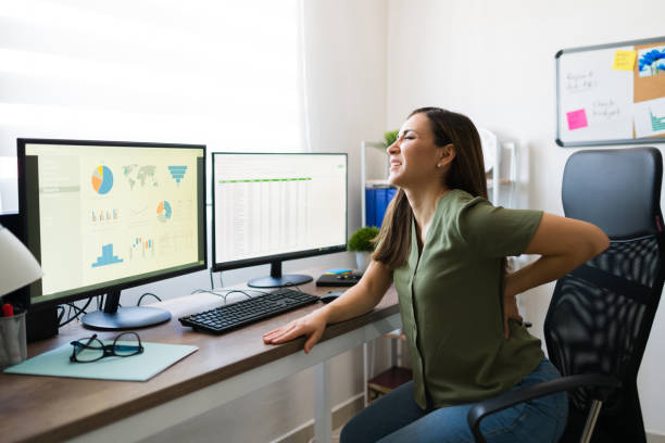 istock Stressed young woman working with back pain 1332378363